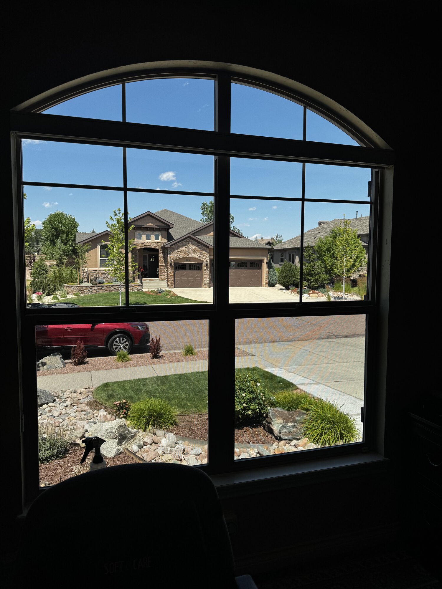 Spotless arched front window after professional cleaning